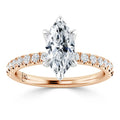 A marquise-cut diamond ring with a rose gold band and small diamonds set along the band.