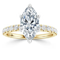 Gold ring with a large marquise-cut diamond center and smaller diamonds set along the band.