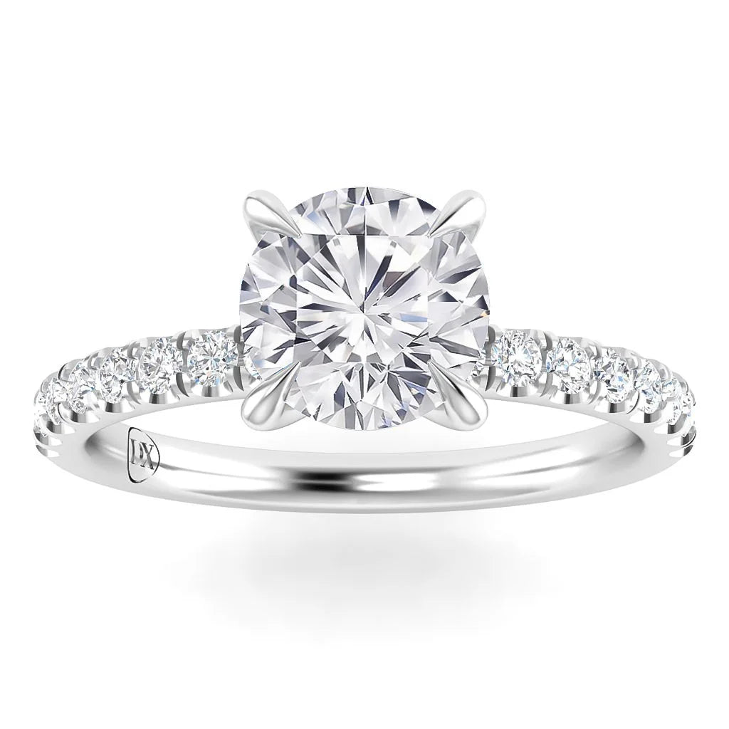 White gold ring with a large round diamond center stone and smaller diamonds on the band, shown on a white background.