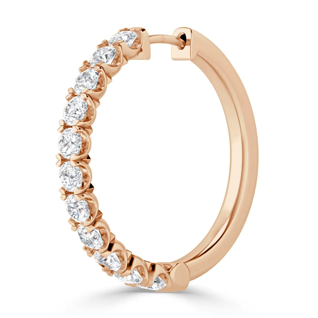 Rose gold hoop earring with a row of round white diamonds set along the front half of the hoop.