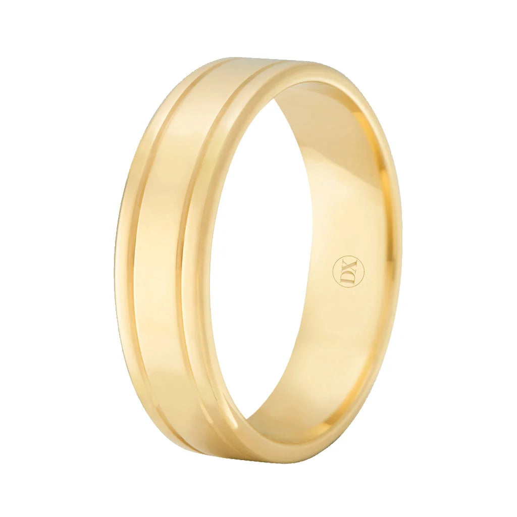 A gold band ring with a grooved line around the center, shown on a plain white background.