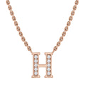 Rose gold chain necklace with a pendant shaped like the letter H, adorned with small clear gemstones.