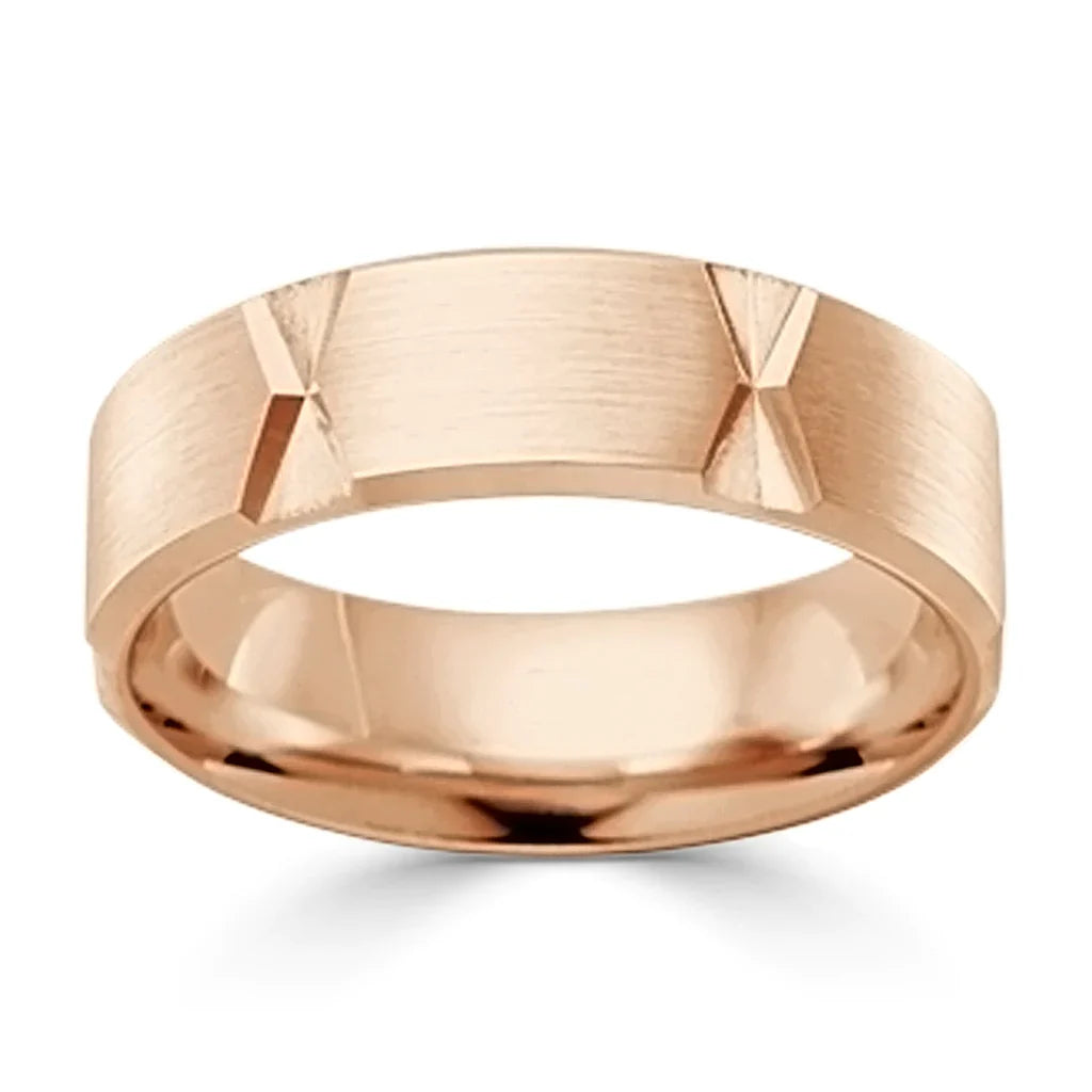 Rose gold ring with a brushed finish and geometric X-shaped indentations around the band.