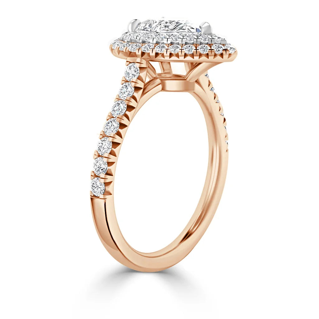 A rose gold ring with a round diamond halo setting and diamond accents along the band, shown from the side.