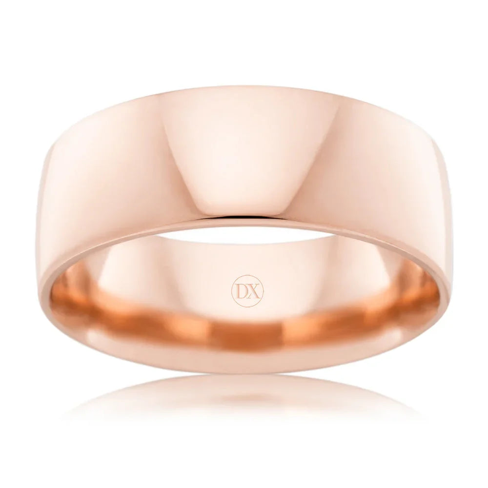 A wide, polished rose gold ring with smooth edges and a subtle DX engraving inside the band.