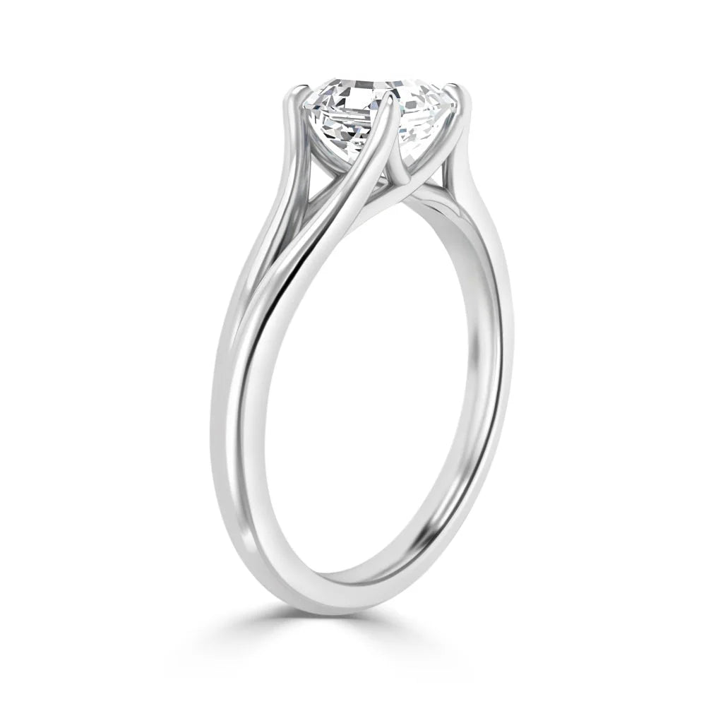 A solitaire diamond engagement ring with a twisted white gold band in a prong setting.
