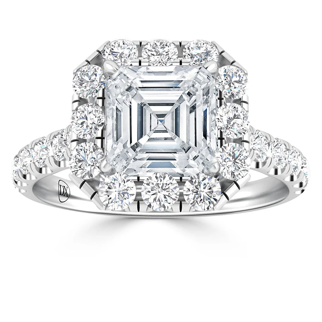 Platinum ring with a large square-cut center diamond, haloed and banded by round brilliant diamonds.