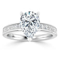 Pear-shaped diamond ring with a channel-set diamond band on a polished white gold setting.