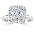 A princess-cut diamond ring with a square halo of round diamonds set on a polished silver band.