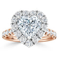 Heart-shaped diamond ring with a halo of smaller diamonds and a rose gold band set with diamonds.