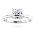 A solitaire ring with an Asscher-cut diamond set on a simple, polished white metal band.