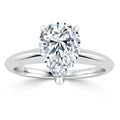 A pear-shaped diamond solitaire ring set on a simple, polished white metal band.
