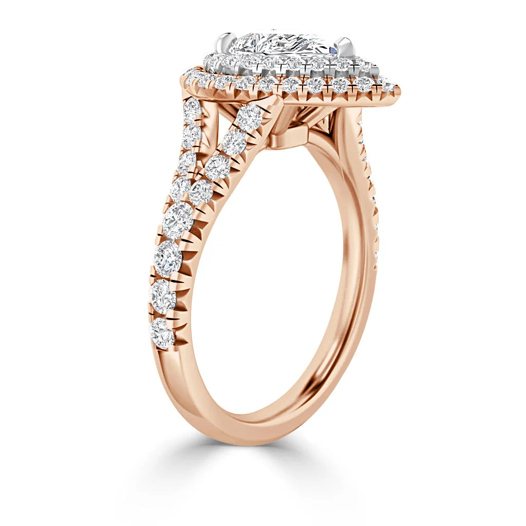 Rose gold ring with a halo setting and pavé diamonds along the band, featuring a large center diamond.