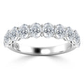 A silver ring with a row of round, sparkling diamonds set along the band in a shared prong setting.