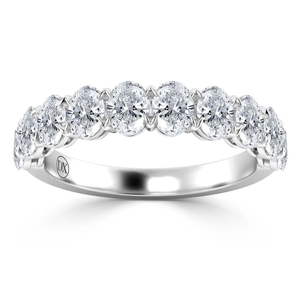A silver ring with a row of round, sparkling diamonds set along the band in a shared prong setting.