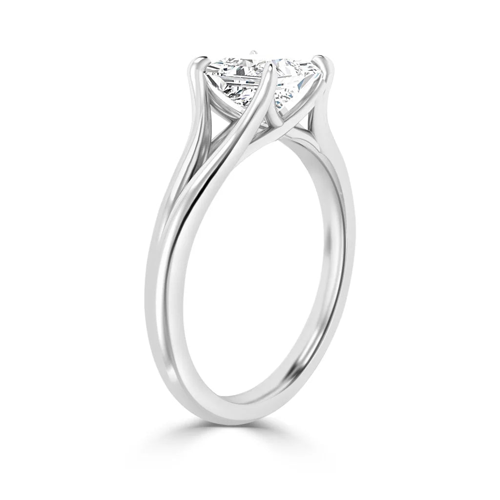 A solitaire diamond ring with a twisted white gold band and a prong-set round diamond center stone.