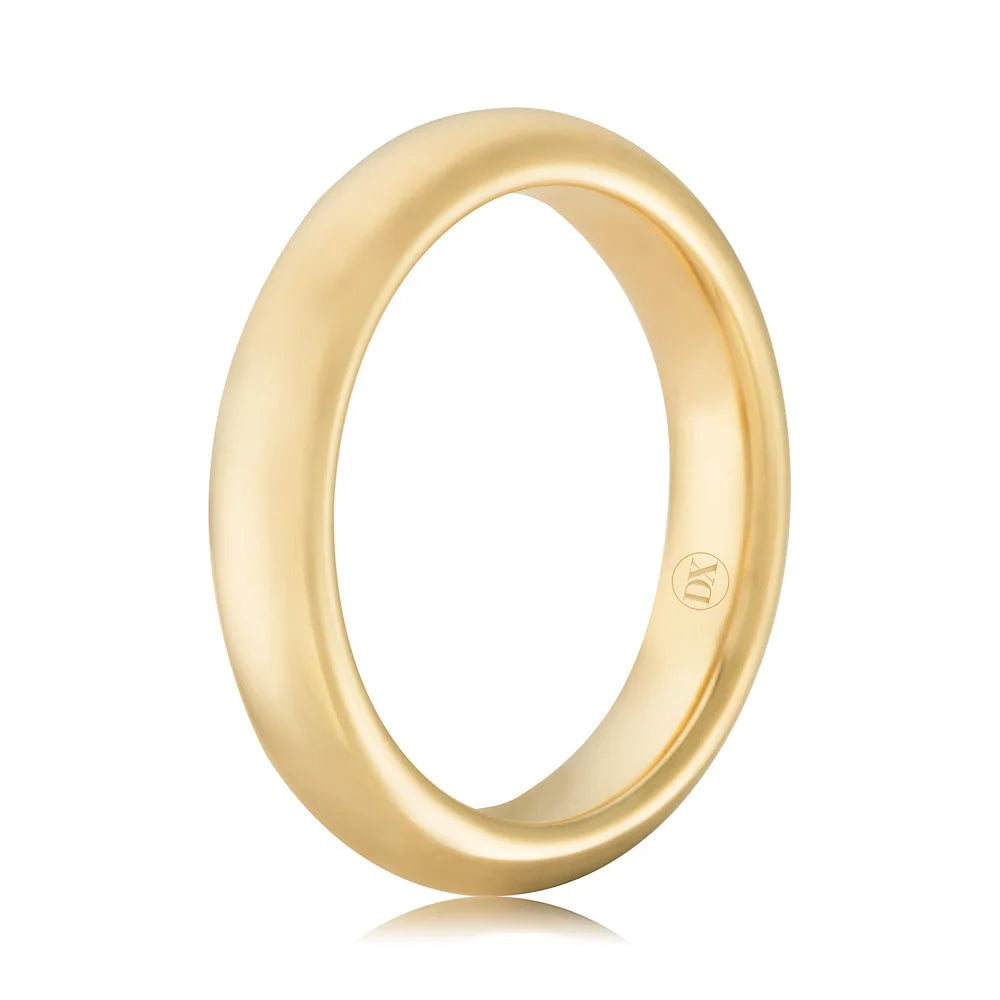 A plain, polished yellow gold ring with a rounded surface and a small engraved logo on the inner band.