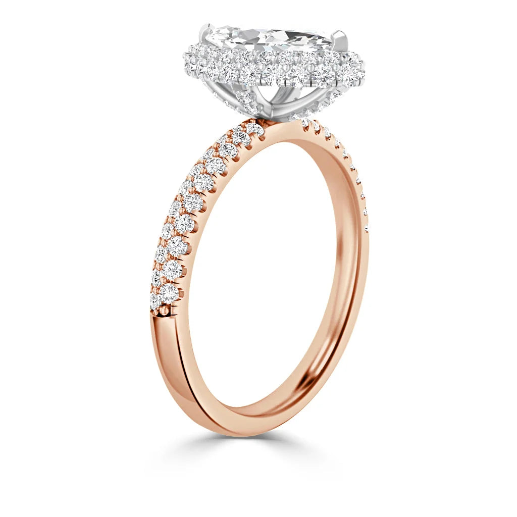 Rose gold ring with a diamond halo setting and pavé diamonds along the slender band, shown upright.