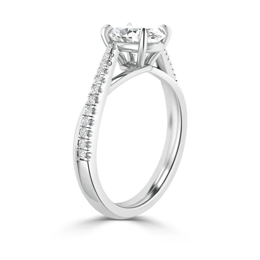 Silver ring with a round center diamond and smaller diamonds set along the band, shown on a white background.