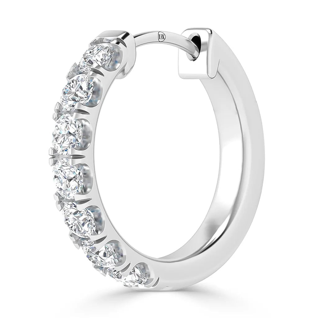 A silver hoop earring adorned with round, sparkling white gemstones set along its front edge.