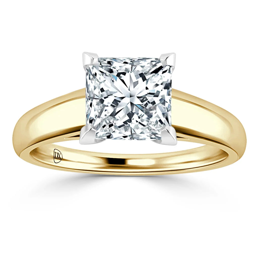 A gold band ring with a large, square-cut diamond in a four-prong setting, displayed on a white background.