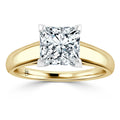 A gold band ring with a large, square-cut diamond in a four-prong setting, displayed on a white background.