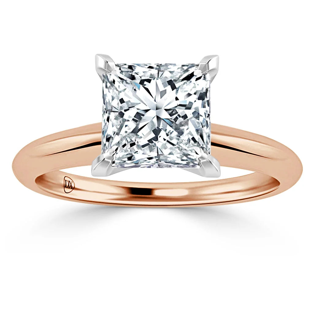A rose gold ring with a large, square-cut diamond set in a four-prong solitaire setting.