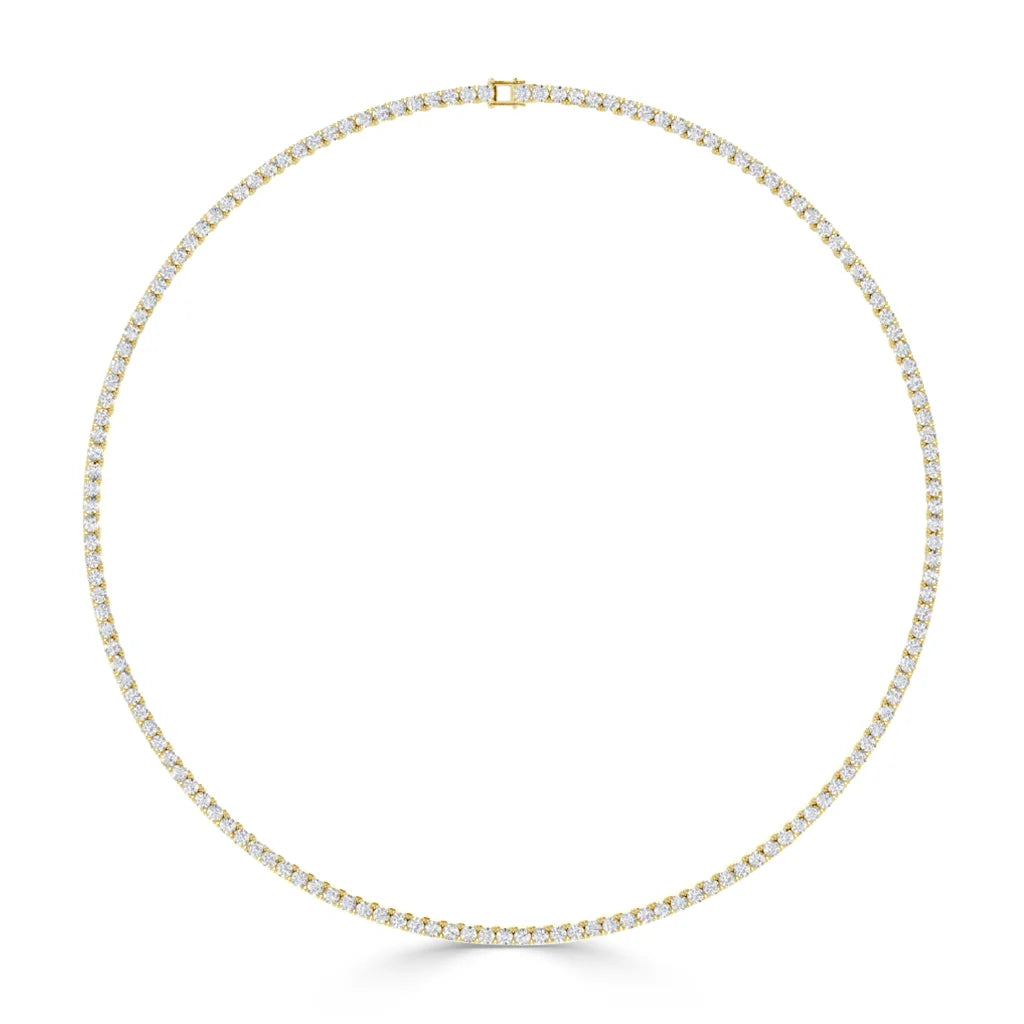 A gold tennis necklace with evenly spaced round white diamonds, displayed in a perfect circle on a white background.