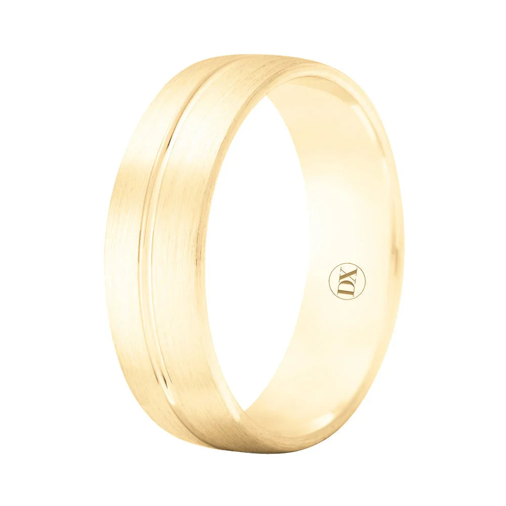 Gold band ring with a subtle brushed finish, a central groove, and a small engraved DY inside.