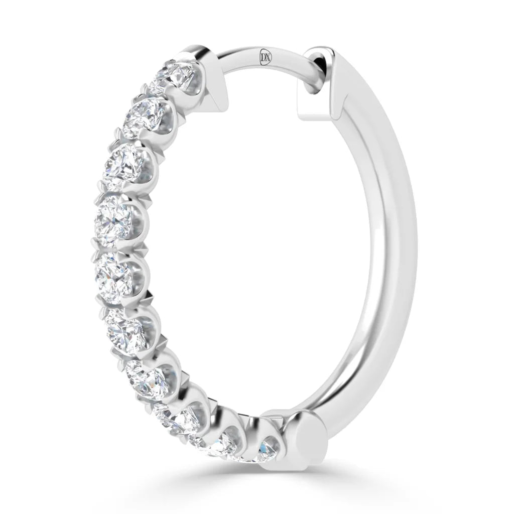 A silver hoop earring with a row of sparkling round-cut diamonds set along the front curve.