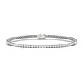 A delicate silver tennis bracelet with a single row of round white diamonds and a secure clasp, on a white background.