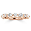 Rose gold ring with alternating round and marquise-cut diamonds set in a delicate, elegant band.