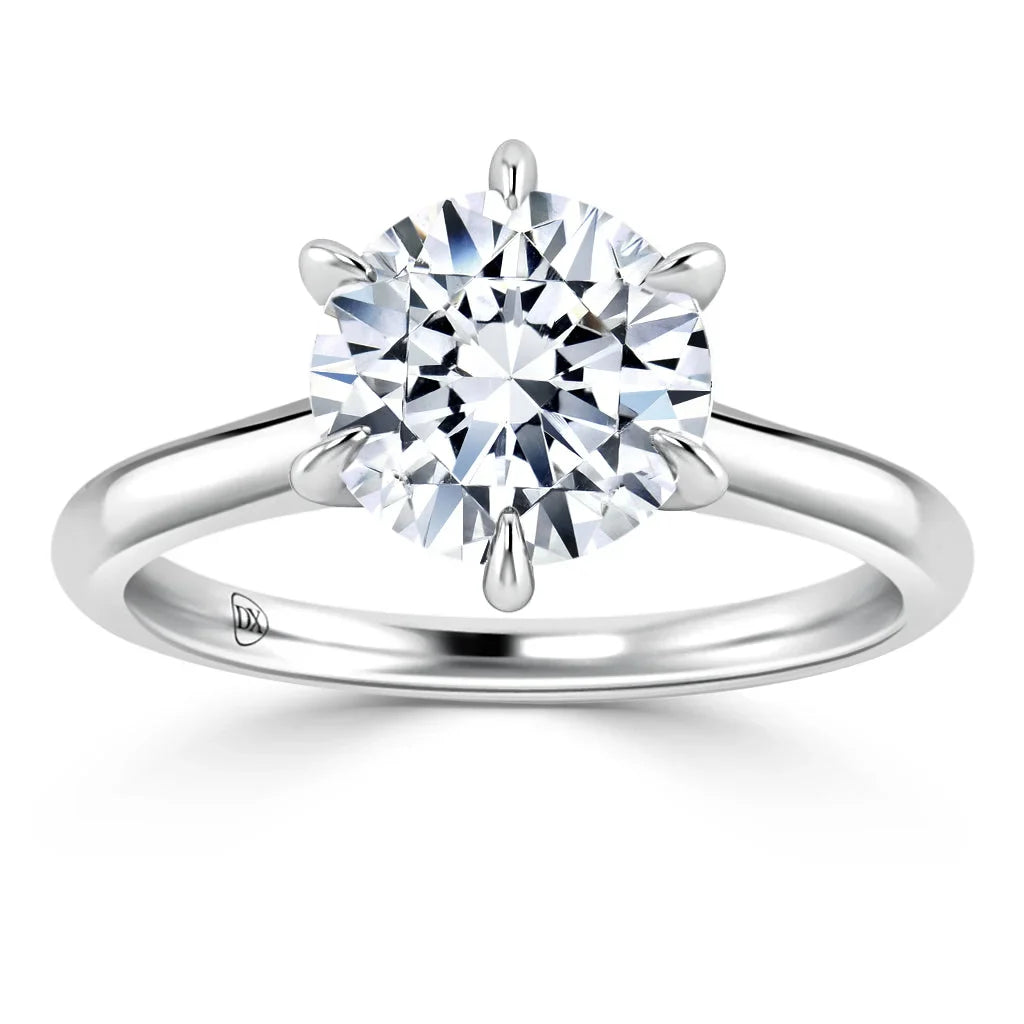 A silver solitaire ring with a round, brilliant-cut diamond set in a six-prong classic band.