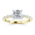 A gold ring with a cushion-cut center diamond and marquise accent diamonds along the band.