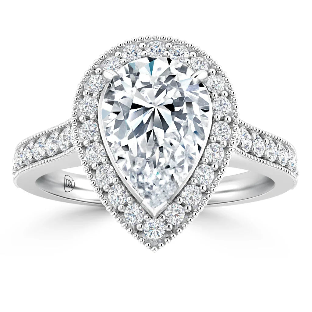A pear-shaped diamond ring with a double halo and pavé diamonds on a white gold band.