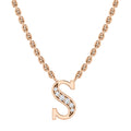 A gold chain necklace with an “S” pendant adorned with small, sparkling diamonds.