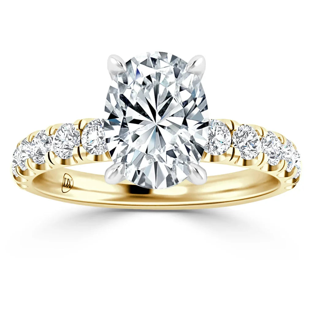 Oval-cut diamond ring with gold band and round side diamonds in a prong setting, viewed from the front.