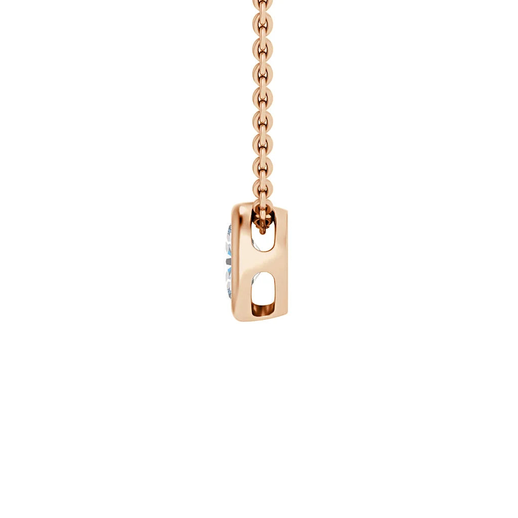 A rose gold chain with a rectangular pendant holding a single round diamond, shown from a side angle.