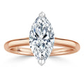 A marquise-cut diamond solitaire ring with a rose gold band, viewed from the top against a white background.