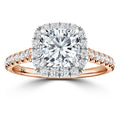 A rose gold ring with a cushion-cut diamond center, surrounded by a halo and pavé diamonds on the band.