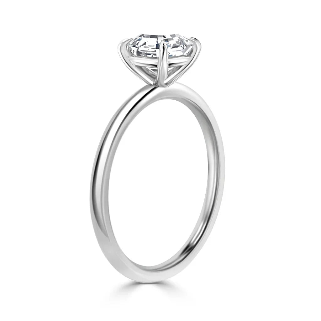 Silver solitaire ring with a single round diamond in a prong setting, displayed on a white background.