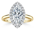 Gold ring with a marquise-cut center diamond, surrounded by a halo of smaller round diamonds.