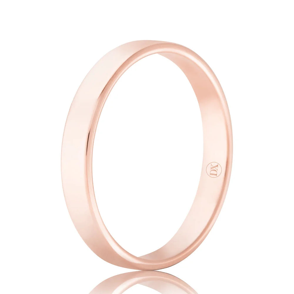 A plain rose gold band ring with a smooth finish and a small engraved symbol on the inner surface.
