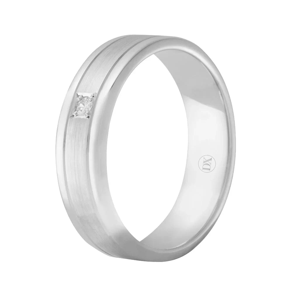 A silver ring with a small square diamond set flush into the brushed metal band, viewed at an angle.