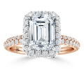 Emerald-cut diamond ring with a halo of smaller diamonds on a rose gold band encrusted with diamonds.