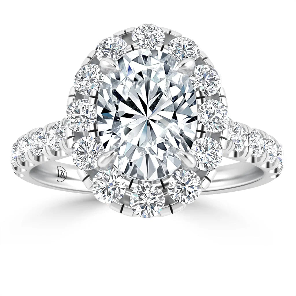 A white gold ring with an oval-cut diamond center, surrounded by a halo of round diamonds on a diamond band.