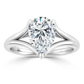 Pear-shaped diamond solitaire ring with a split shank white gold band on a white background.