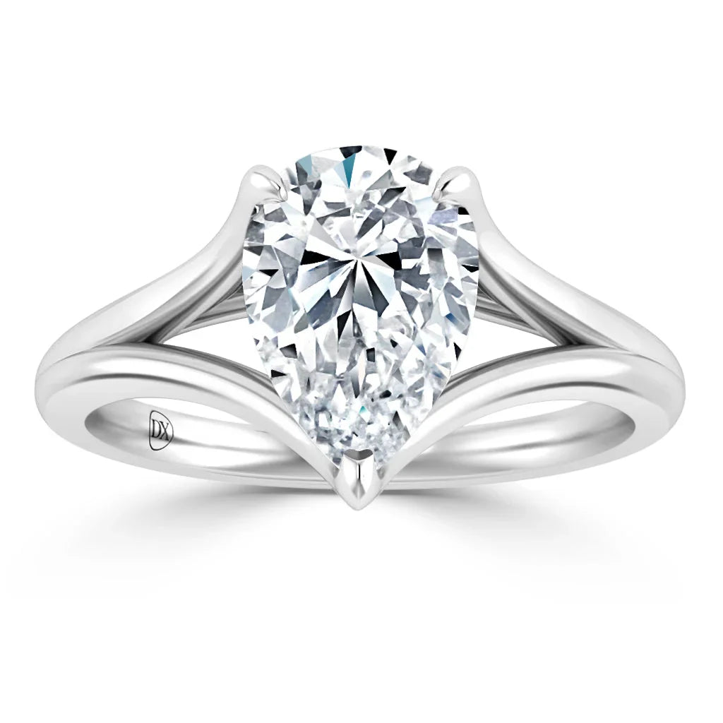 Pear-shaped diamond solitaire ring with a split shank white gold band on a white background.