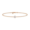 Delicate rose gold chain bracelet with a single round bezel-set diamond in the center, and a clasp closure.