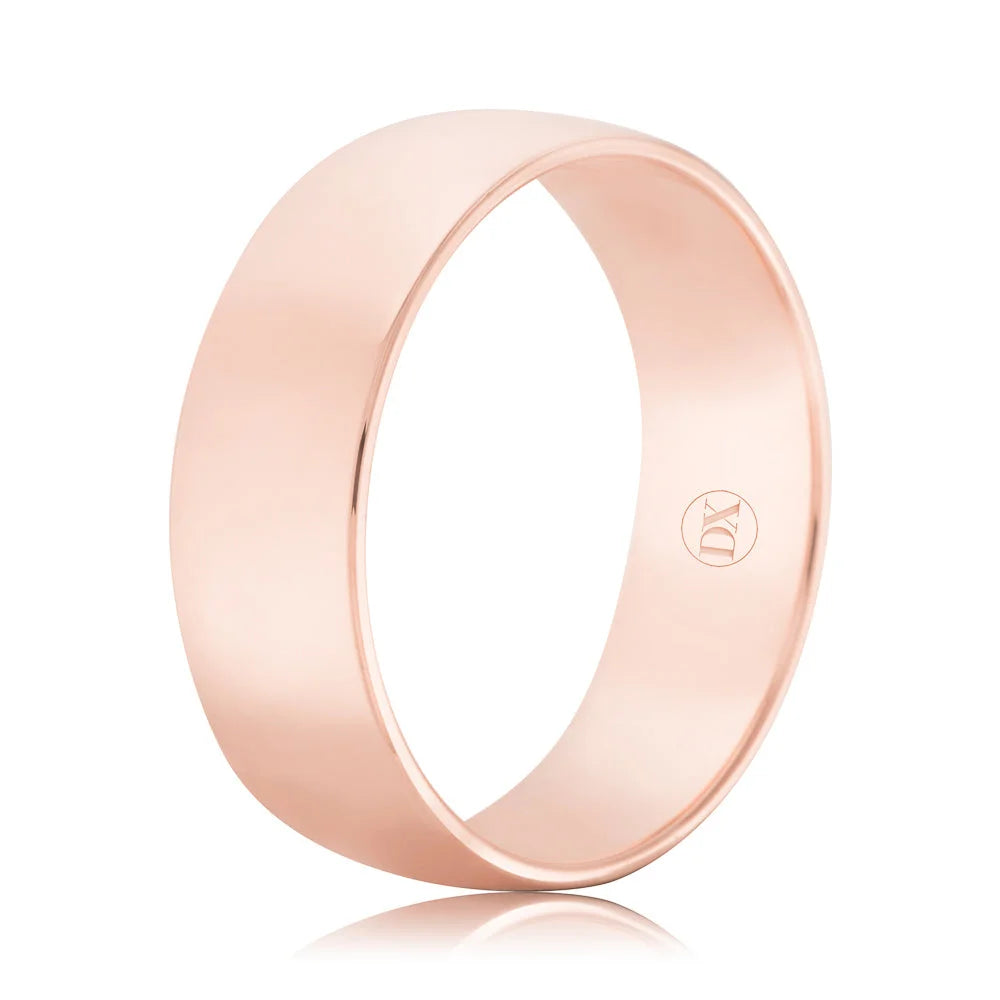 A plain, polished rose gold band ring with a small engraved logo on the inner surface.